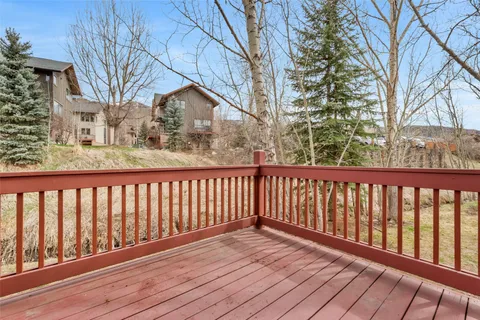 a balcony with wooden floor and fence