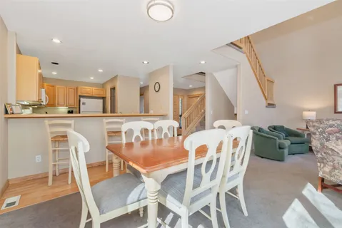 a dining room with furniture and a view of kitchen