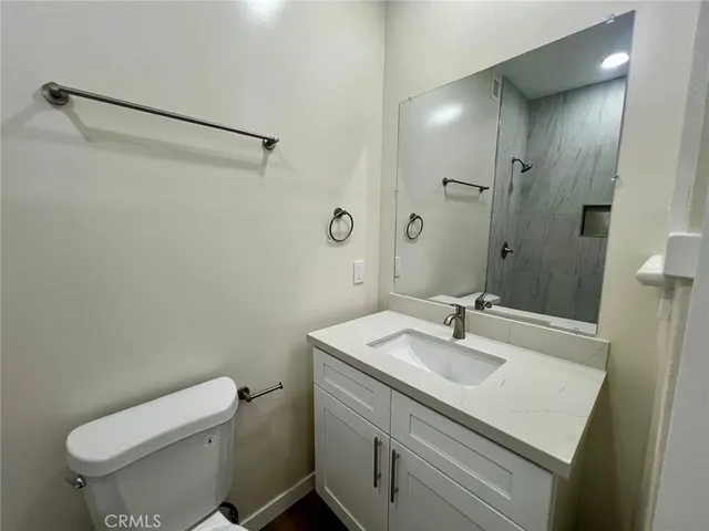 a bathroom with a sink toilet and vanity