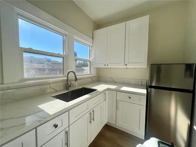 a kitchen with a sink cabinets and window