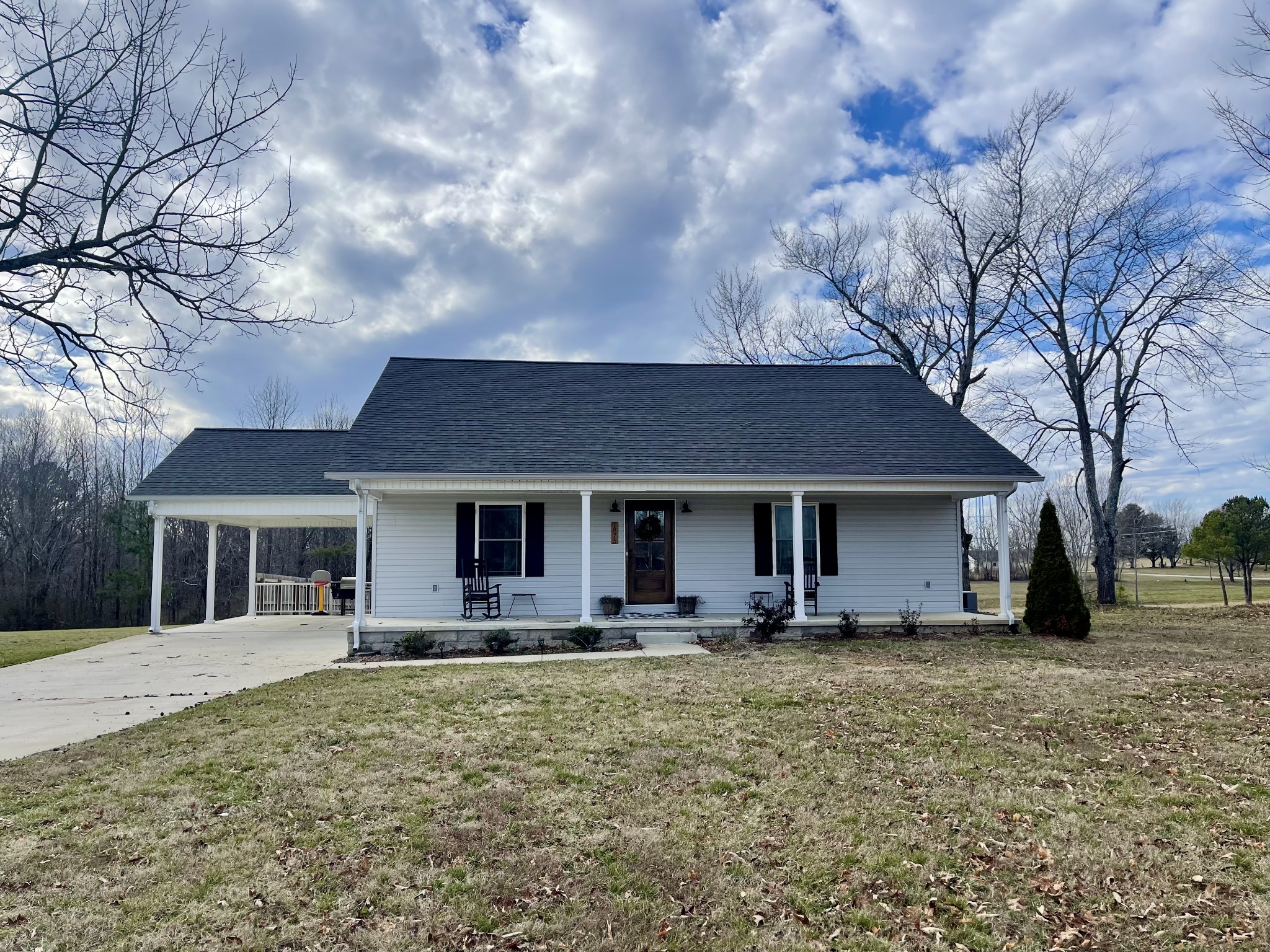 1875 Fall River Road Leoma, TN 38468 - Photo 1 of 18 a front view of house with yard and trees in the background