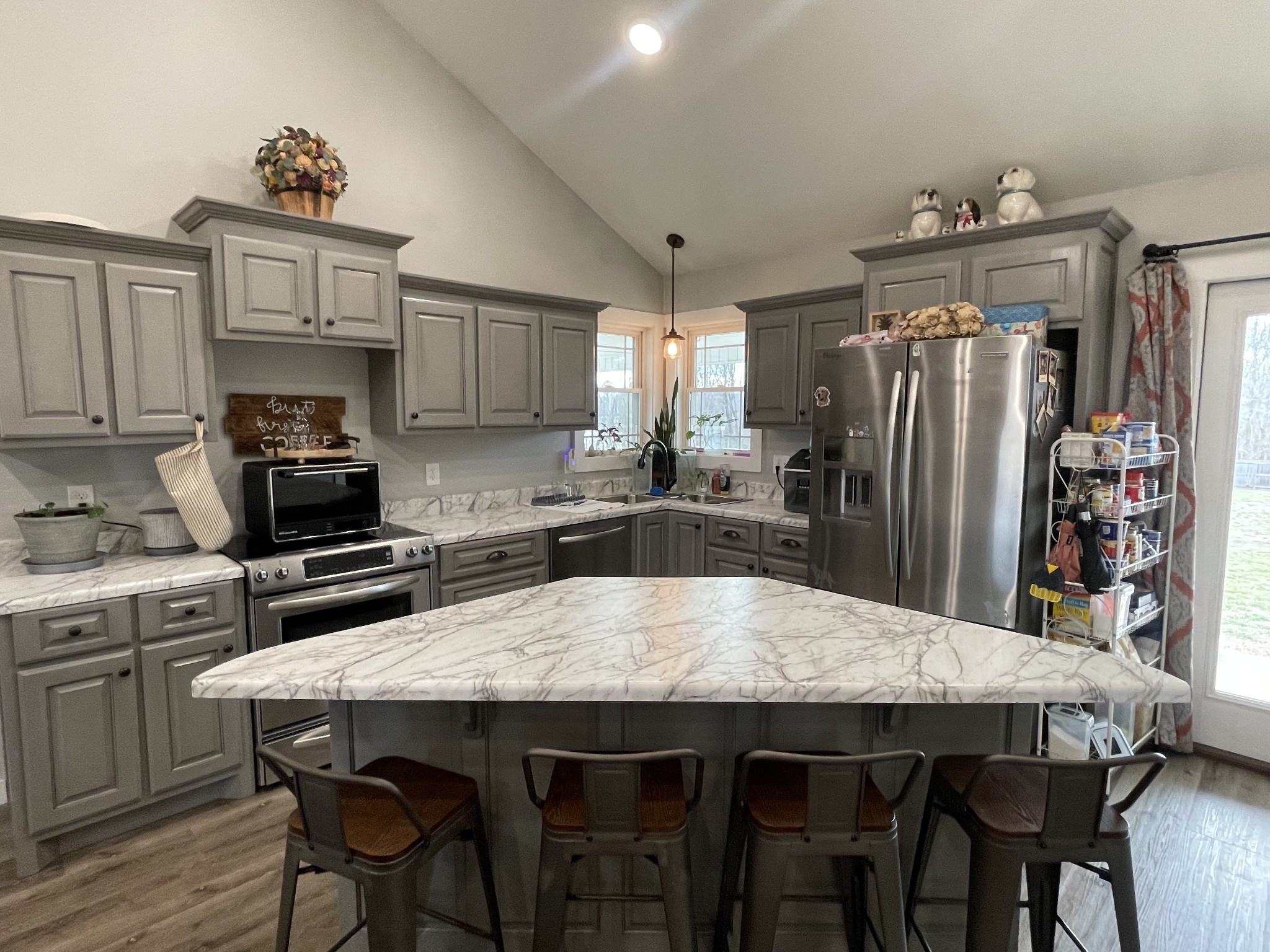 1875 Fall River Road Leoma, TN 38468 - Photo 8 of 18 a kitchen with stainless steel appliances a table chairs and a refrigerator