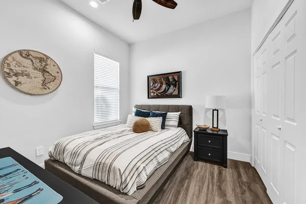 a bedroom with a bed and a lamp next to a window