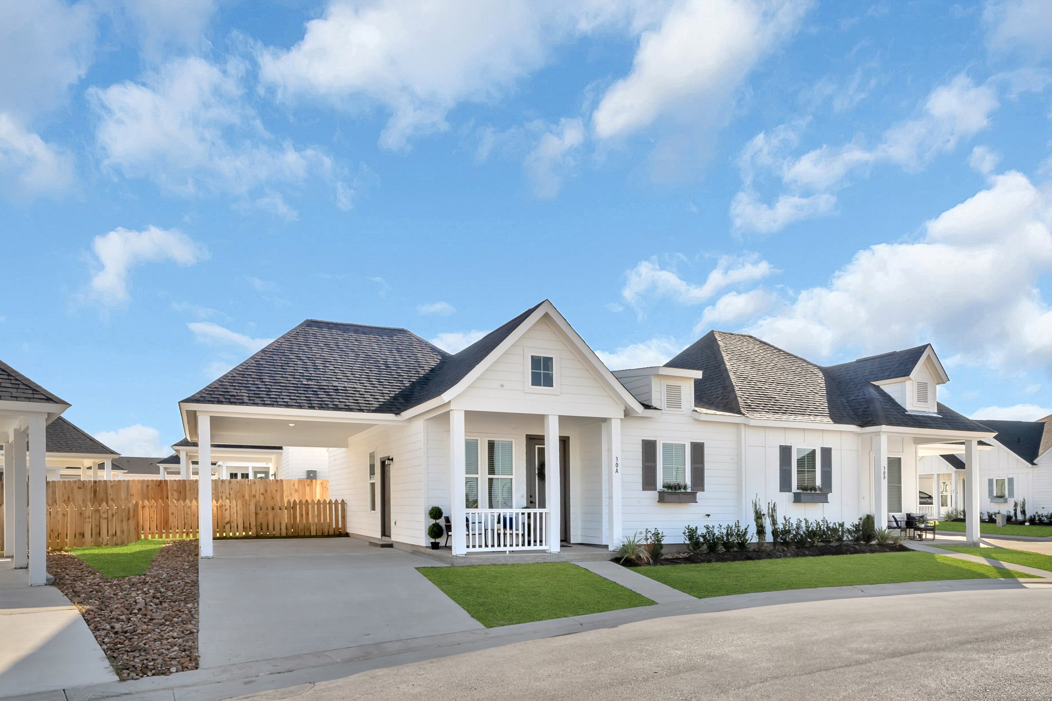 38634 Spur 149 Road, Unit 15B Magnolia, TX 77354 - Photo 48 of 50 a front view of multiple houses with yard and green space