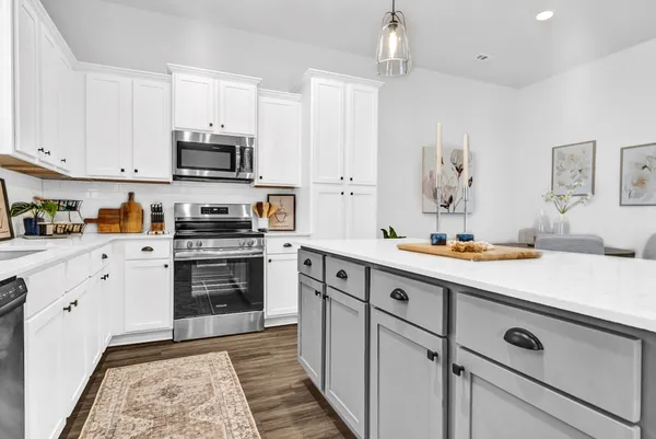 a kitchen with stainless steel appliances a stove sink and microwave