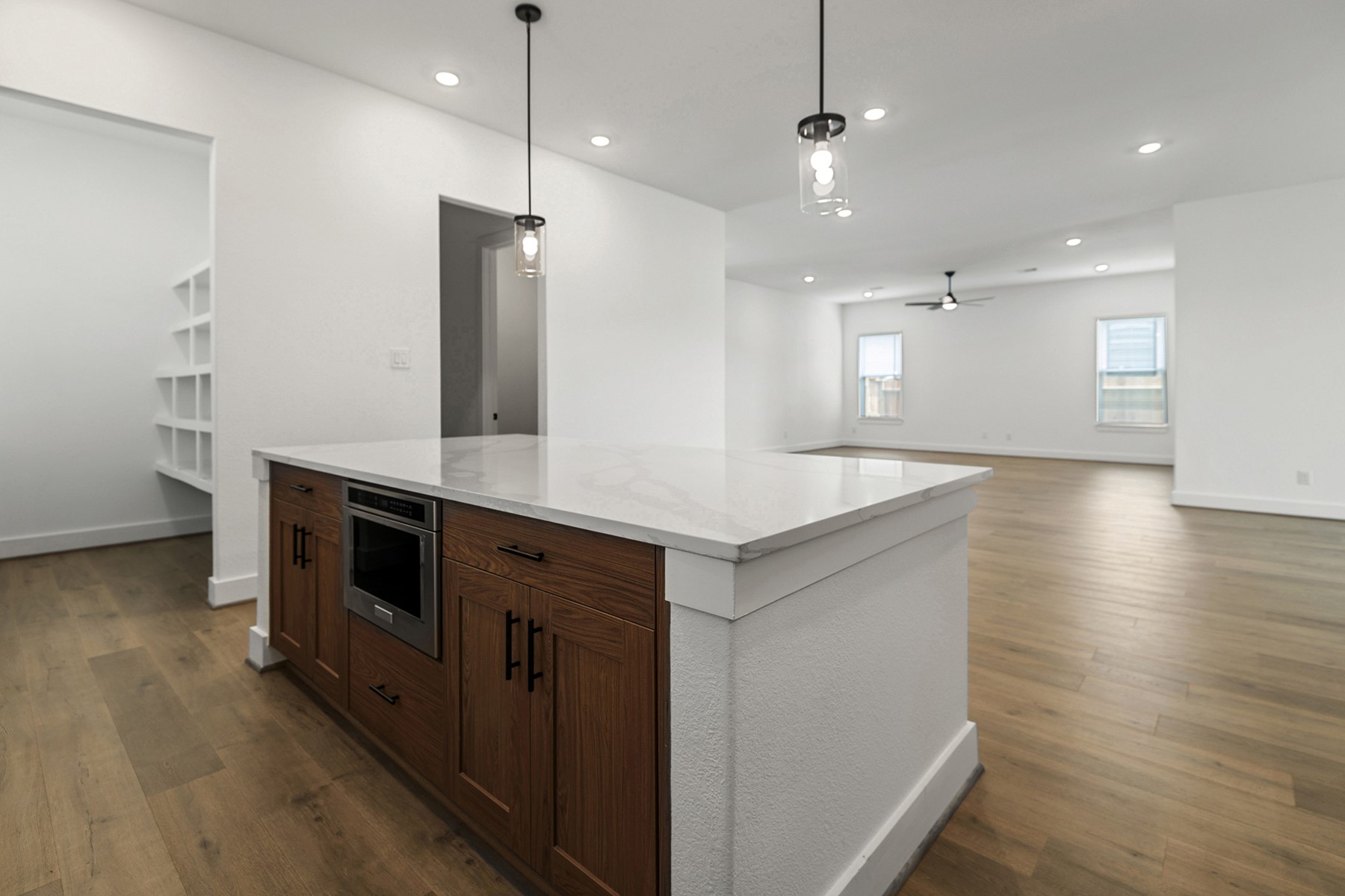 1813 Drover Lane Rosenberg, TX 77471 - Photo 11 of 23 a large kitchen with stainless steel appliances a large counter top a stove a sink and a refrigerator