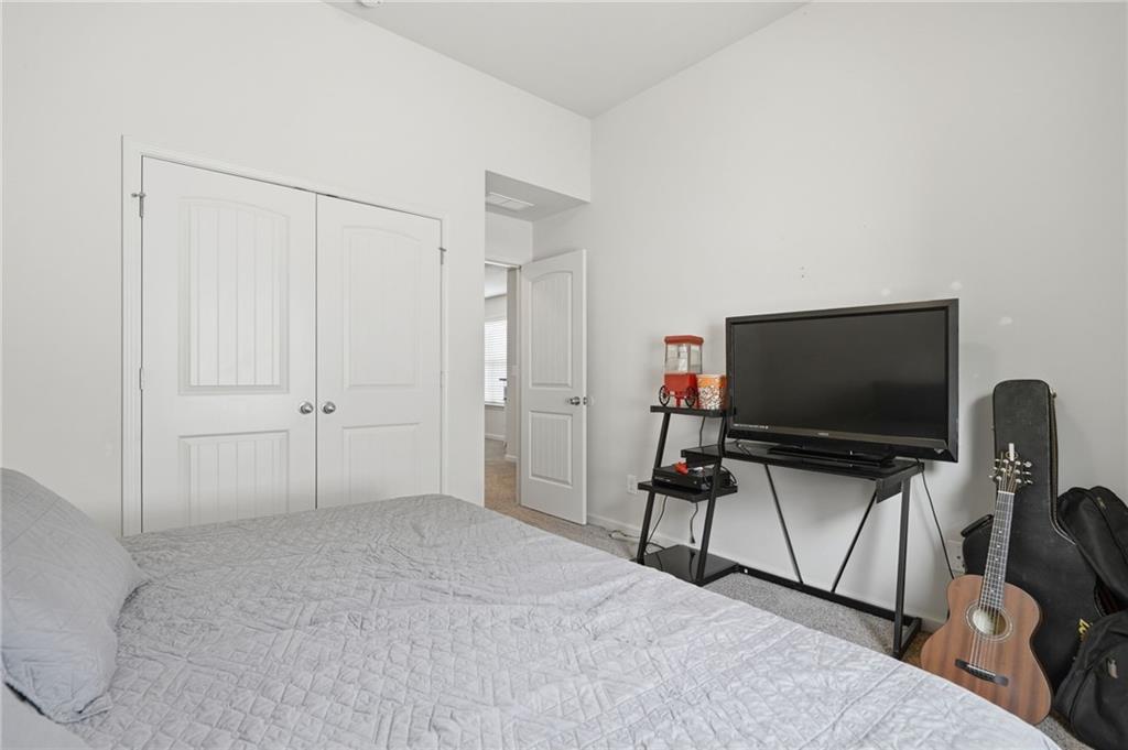 123 Renford Road Ball Ground, GA 30107 - Photo 21 of 27 a bedroom with a bed and a flat screen tv