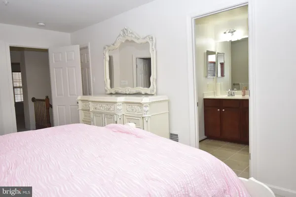 a bedroom with a bed and a mirror