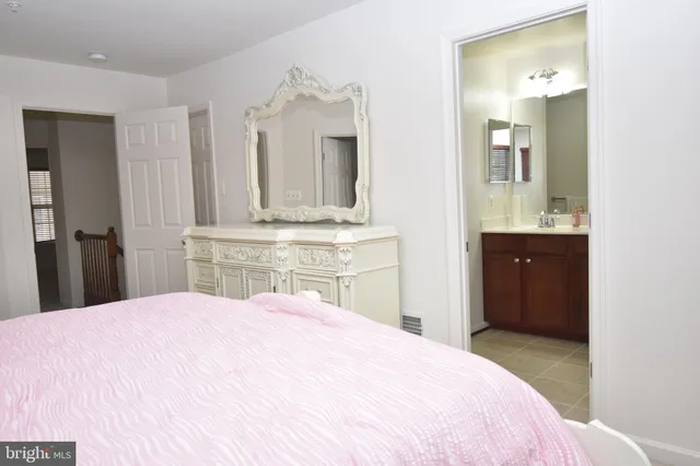 a bedroom with a bed and a mirror
