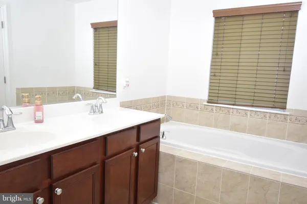a bathroom with a bathtub and a sink