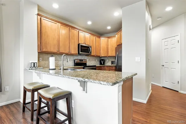 a kitchen with kitchen island granite countertop wooden cabinets and a granite counter tops