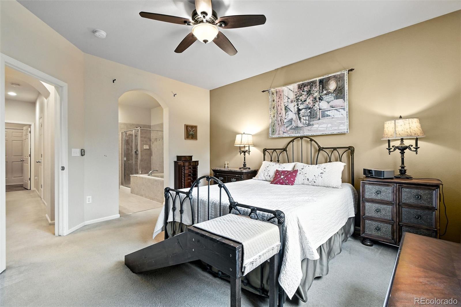 12804 Harrison Street Thornton, CO 80241 - Photo 20 of 37 a bedroom with a bed and a chandelier