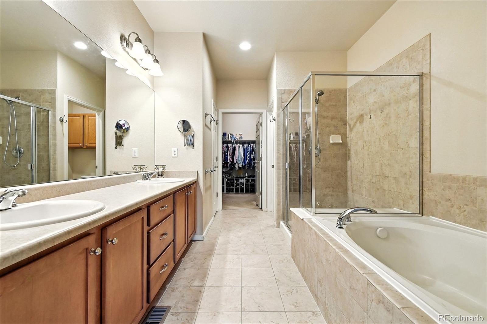 12804 Harrison Street Thornton, CO 80241 - Photo 21 of 37 a spacious bathroom with a large tub shower double sink and mirror