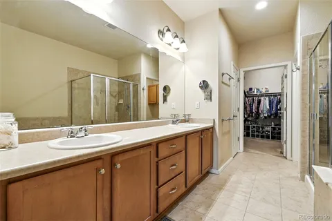 a spacious bathroom with a granite countertop sink mirror and shower