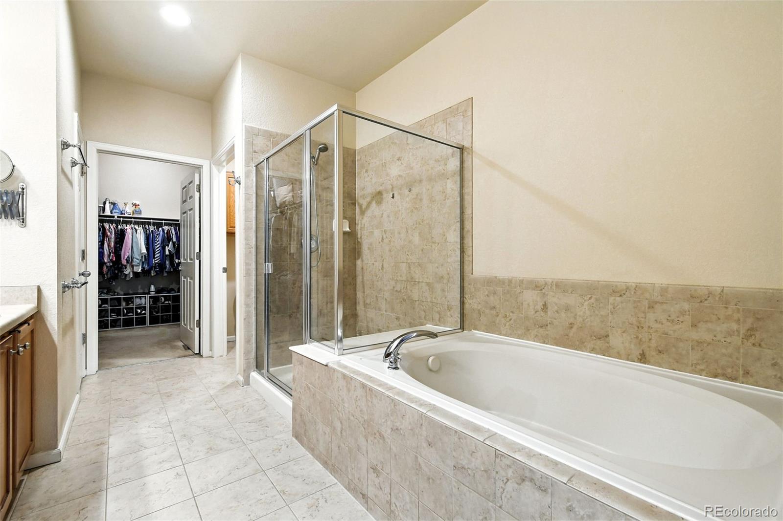 12804 Harrison Street Thornton, CO 80241 - Photo 23 of 37 a bathroom with a bathtub and a shower
