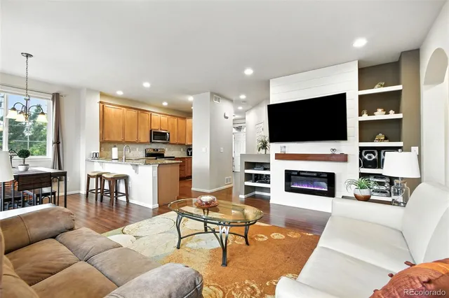 a living room with furniture a fireplace and a flat screen tv