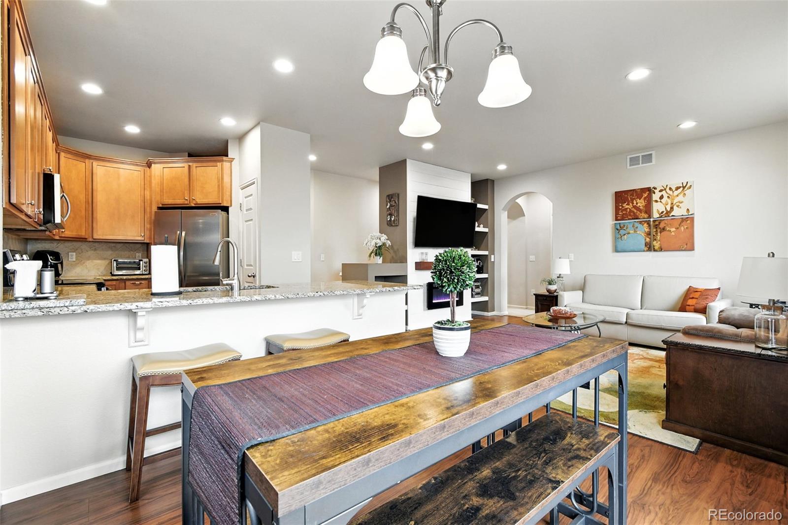 12804 Harrison Street Thornton, CO 80241 - Photo 10 of 37 a kitchen with a dining table and chairs