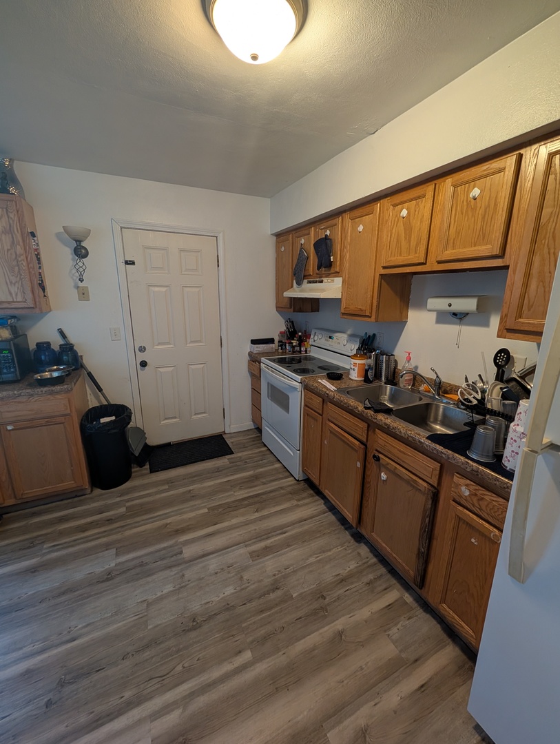6232-6234 Appomattox Road Davenport, IA 52806 - Photo 14 of 21 a kitchen with stainless steel appliances granite countertop a stove a sink and a refrigerator