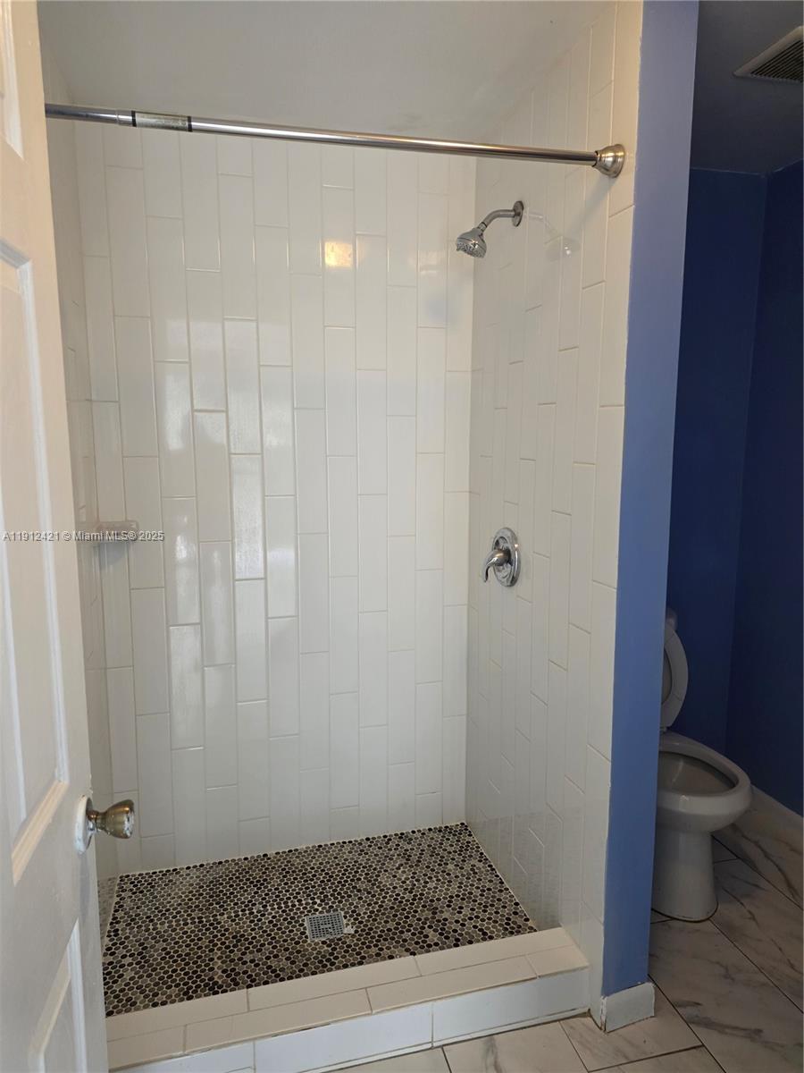 2124 South Beech Road, Unit B West Palm Beach, FL 33409 - Photo 11 of 12 a bathroom with a shower and a toilet