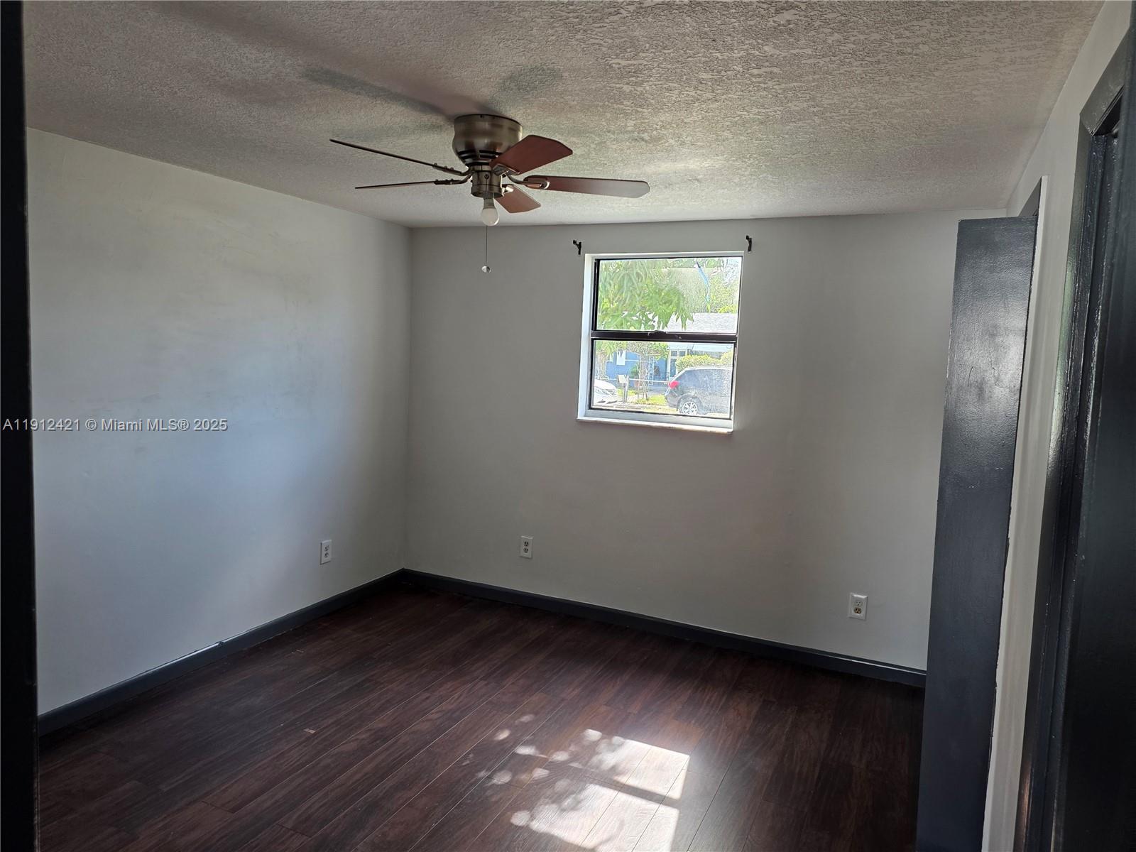2124 South Beech Road, Unit B West Palm Beach, FL 33409 - Photo 6 of 12 a view of empty room with wooden floor and fan