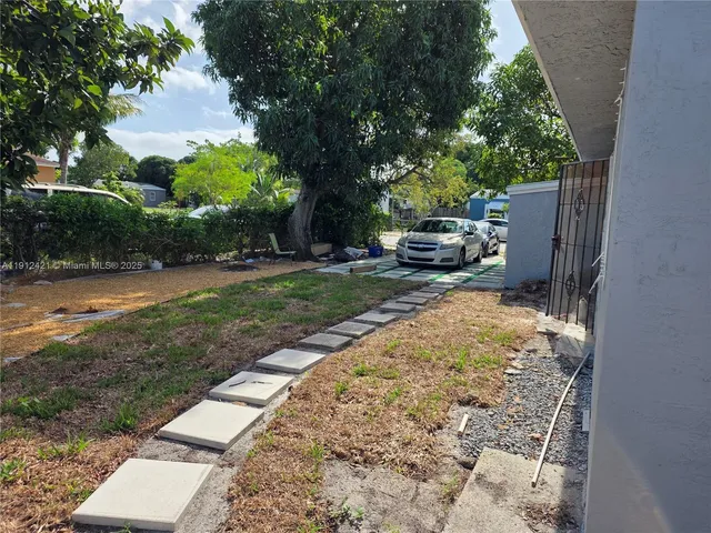 a view of a backyard with sitting area