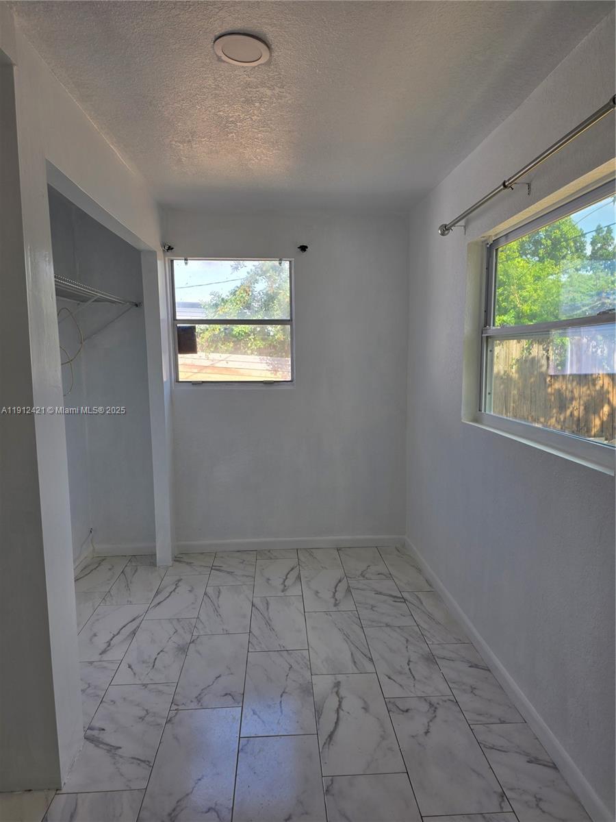 2124 South Beech Road, Unit B West Palm Beach, FL 33409 - Photo 10 of 12 a view of an empty room with a window