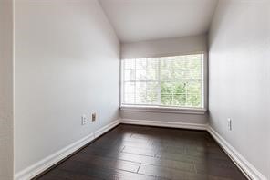 1318 Peden Street, Unit D Houston, TX 77006 - Photo 15 of 33 an empty room with wooden floor and windows