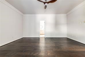 1318 Peden Street, Unit D Houston, TX 77006 - Photo 20 of 33 an empty room with wooden floor and windows