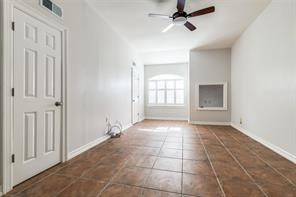 1318 Peden Street, Unit D Houston, TX 77006 - Photo 23 of 33 an empty room with windows and ceiling fan