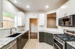 1318 Peden Street, Unit D Houston, TX 77006 - Photo 8 of 33 a kitchen with stainless steel appliances granite countertop a sink stove and refrigerator