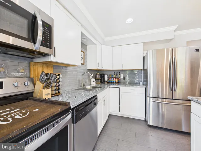 a kitchen with a stove and a refrigerator