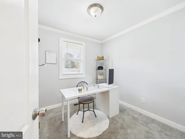 a view of a room with furniture and wooden floor