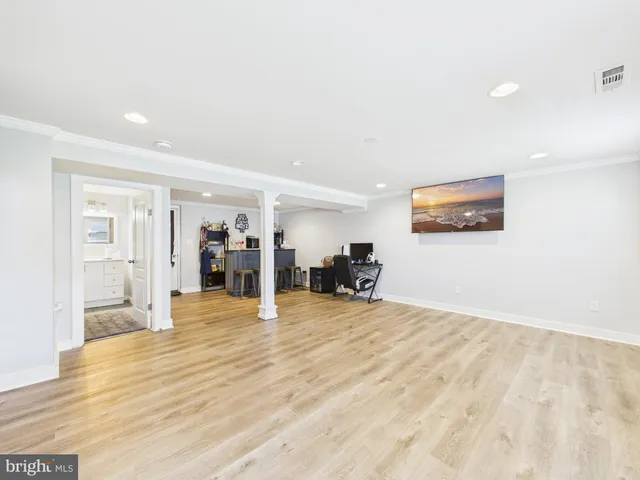 a bathroom with a toilet a sink a mirror and vanity