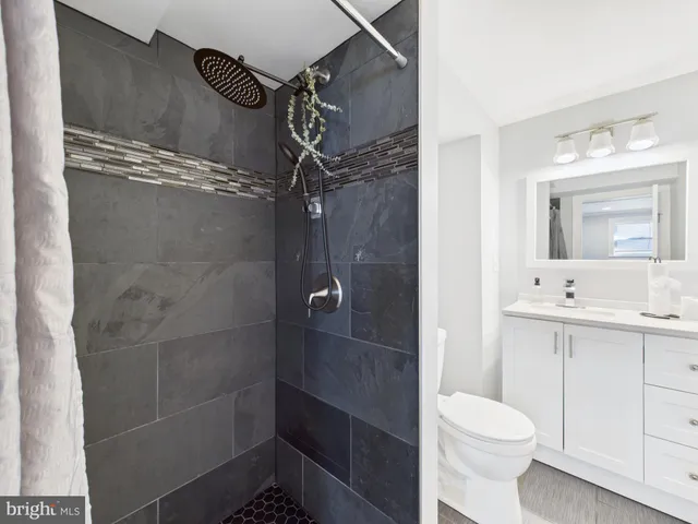 a view of a roof deck with wooden fence and plants