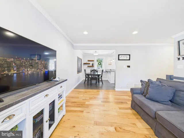a living room with furniture and view of kitchen