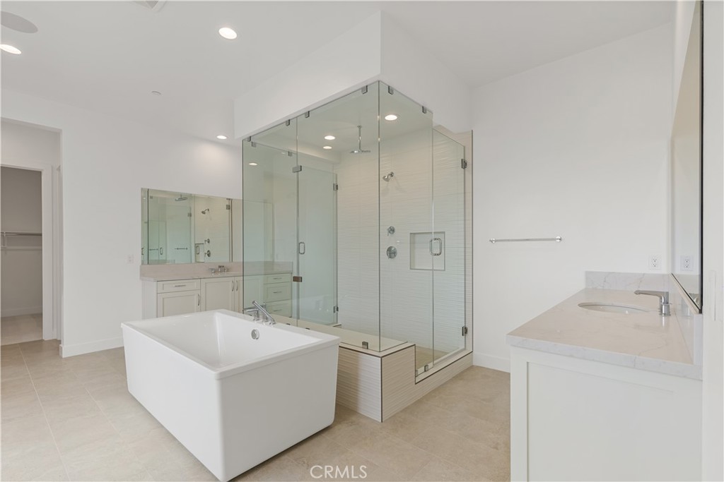 11864 Red Hawk Lane Porter Ranch, CA 91326 - Photo 12 of 15 a bathroom with a tub sink shower and mirror