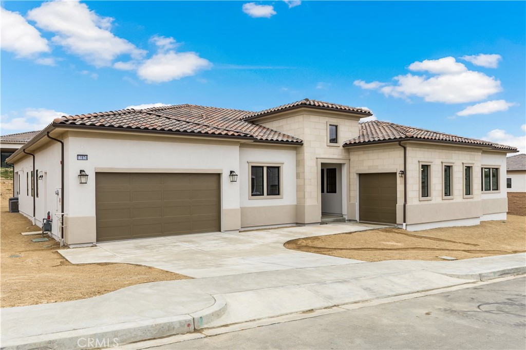 11864 Red Hawk Lane Porter Ranch, CA 91326 - Photo 2 of 15 a front view of a house with a garage