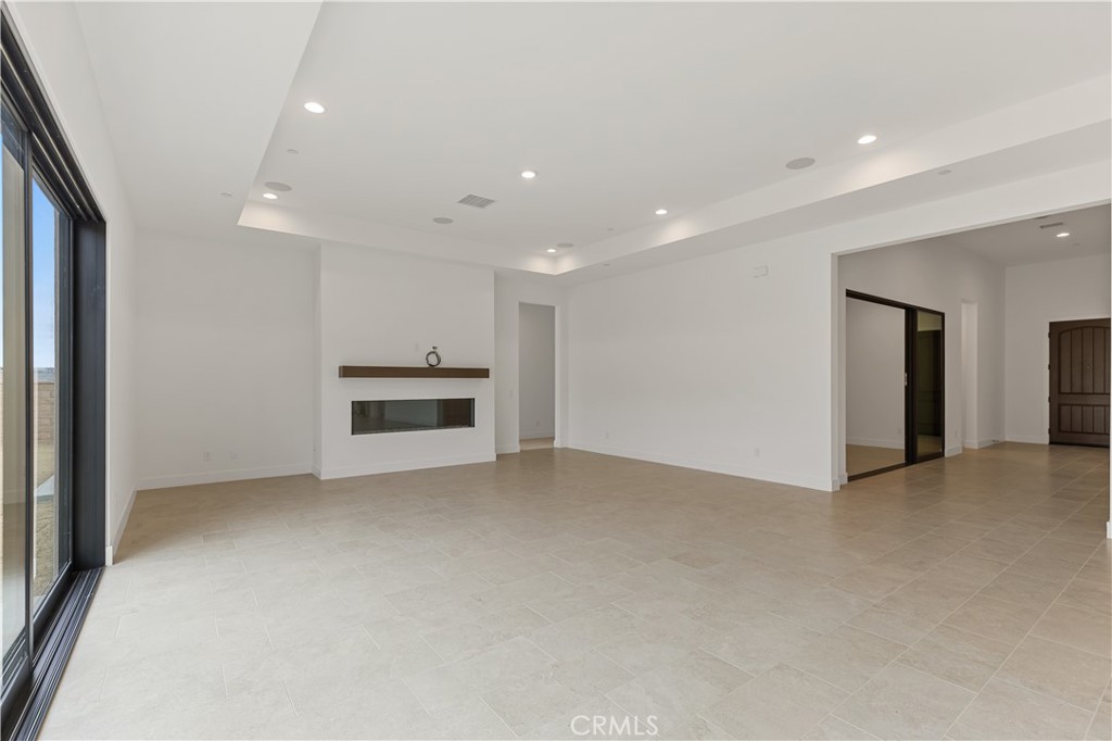 11864 Red Hawk Lane Porter Ranch, CA 91326 - Photo 5 of 15 an empty room with a fireplace and cabinet