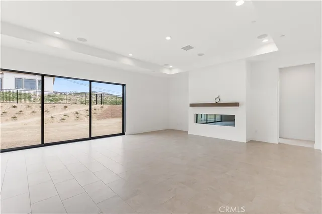 a view of an empty room with a fireplace