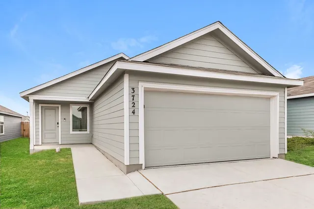 an empty room with wooden floor chandelier fan and windows