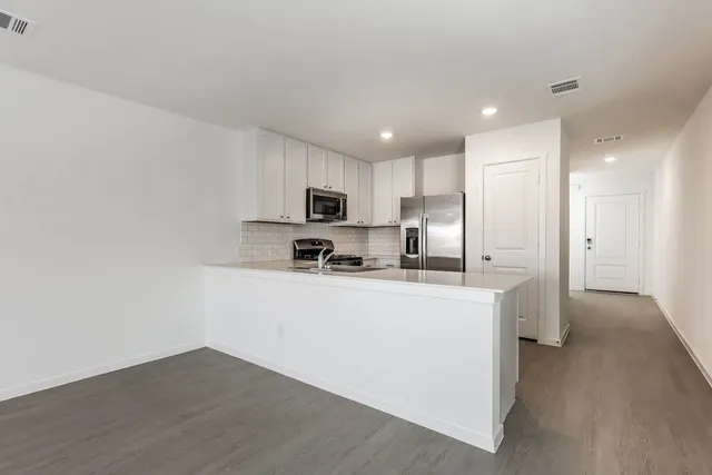 a kitchen with stainless steel appliances granite countertop a stove and a sink