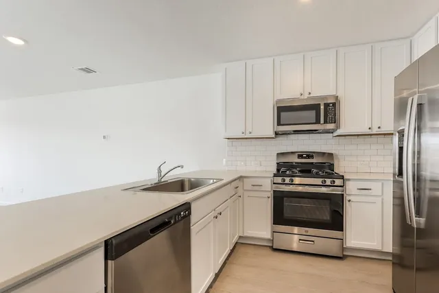 an empty room with chandelier fan