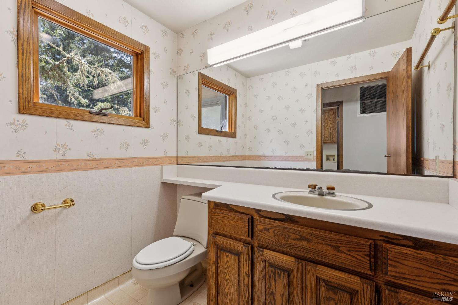 21540 Siri Road Guerneville, CA 95446 - Photo 14 of 99 a bathroom with a toilet sink and mirror