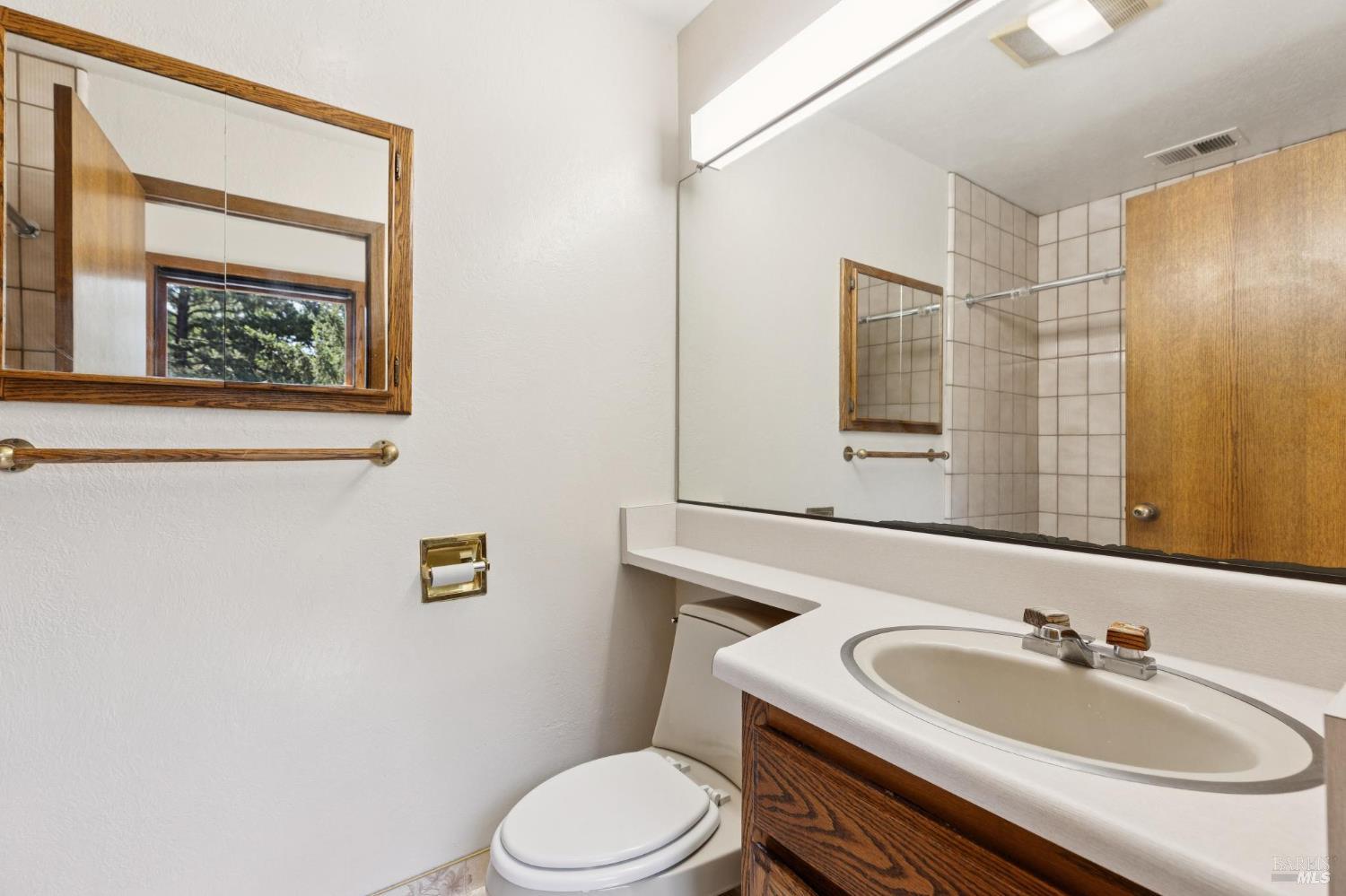 21540 Siri Road Guerneville, CA 95446 - Photo 39 of 99 a bathroom with a sink mirror vanity and toilet