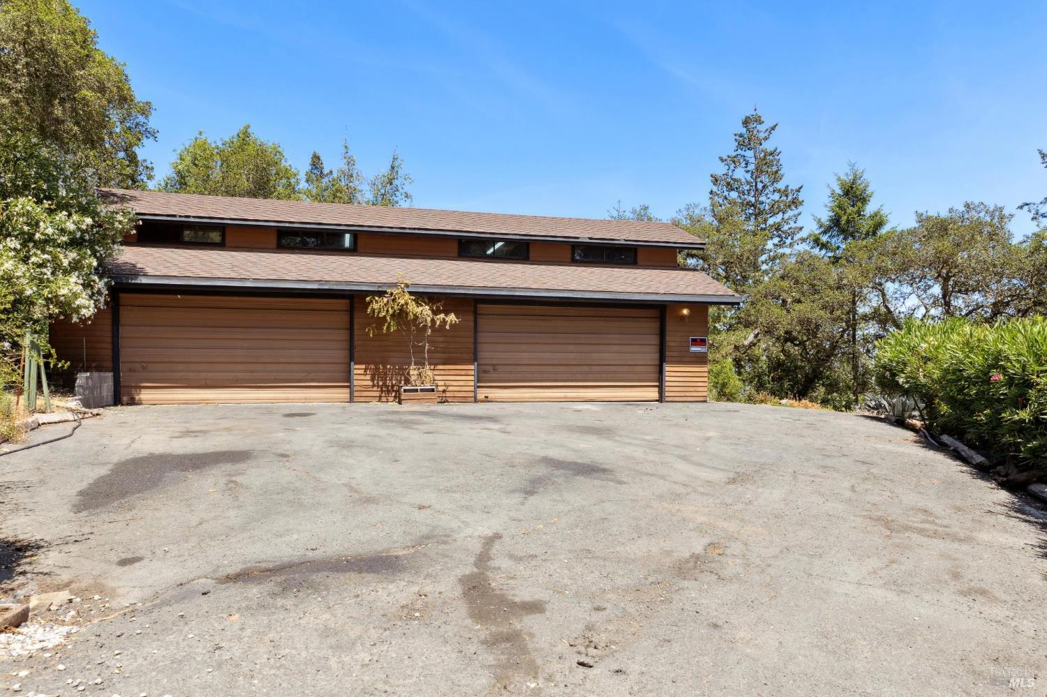 21540 Siri Road Guerneville, CA 95446 - Photo 65 of 99 a front view of a house with a yard and garage