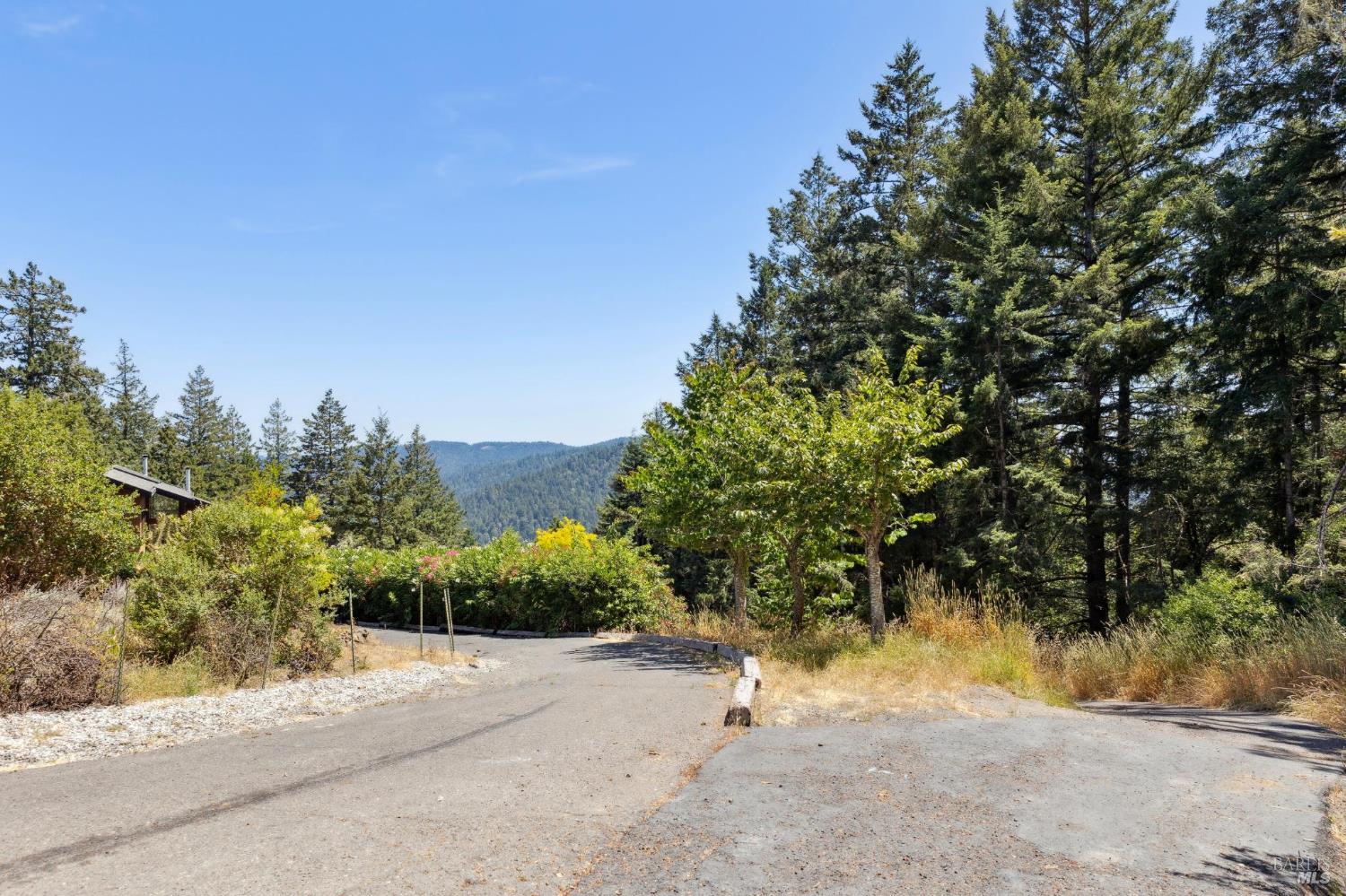 21540 Siri Road Guerneville, CA 95446 - Photo 96 of 99 a view of a road with a building in the background