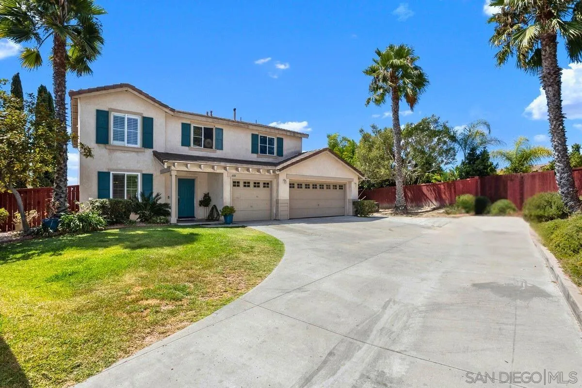 408 Shadow Tree Drive Oceanside, CA 92058 - Photo 1 of 29 a front view of a house with a yard and garage