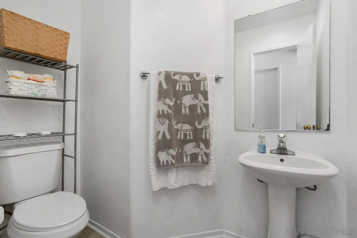 408 Shadow Tree Drive Oceanside, CA 92058 - Photo 11 of 29 a bathroom with a sink toilet and mirror