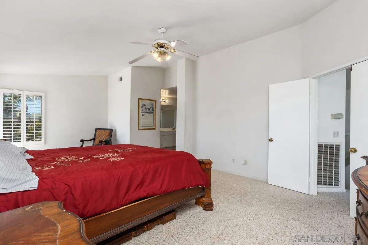 408 Shadow Tree Drive Oceanside, CA 92058 - Photo 14 of 29 a bedroom with a bed and a table