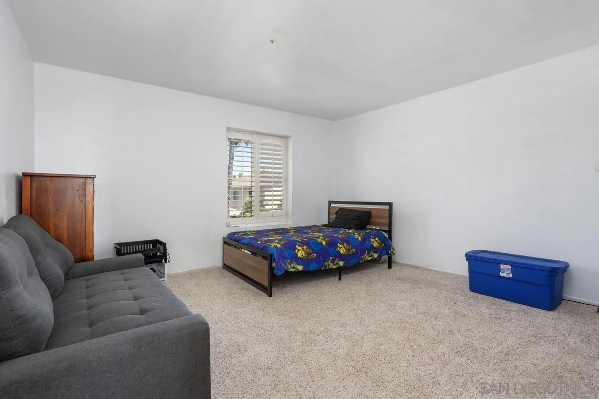 408 Shadow Tree Drive Oceanside, CA 92058 - Photo 20 of 29 a bedroom with a bed and a couch